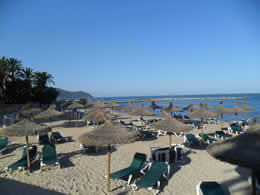 cala bona beach with sunbeds and parasols